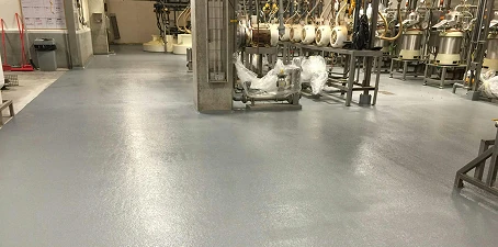 Electrostatic dissipating ESD flooring—gray coated surface in a manufacturing facility designed for static control.